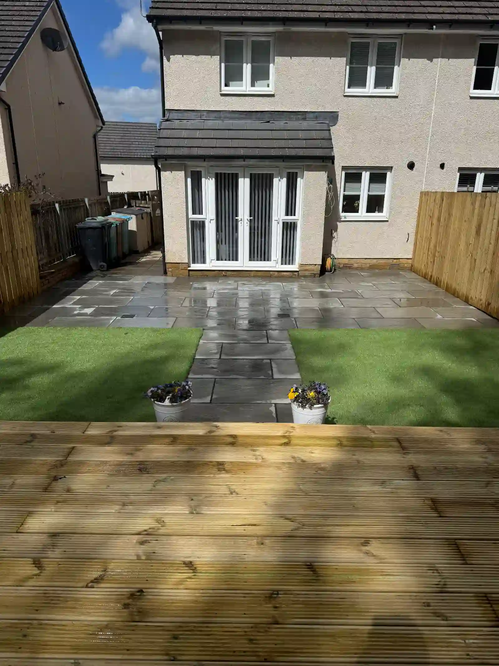 Slate patio and path with artificial grass, timber decking and fencing