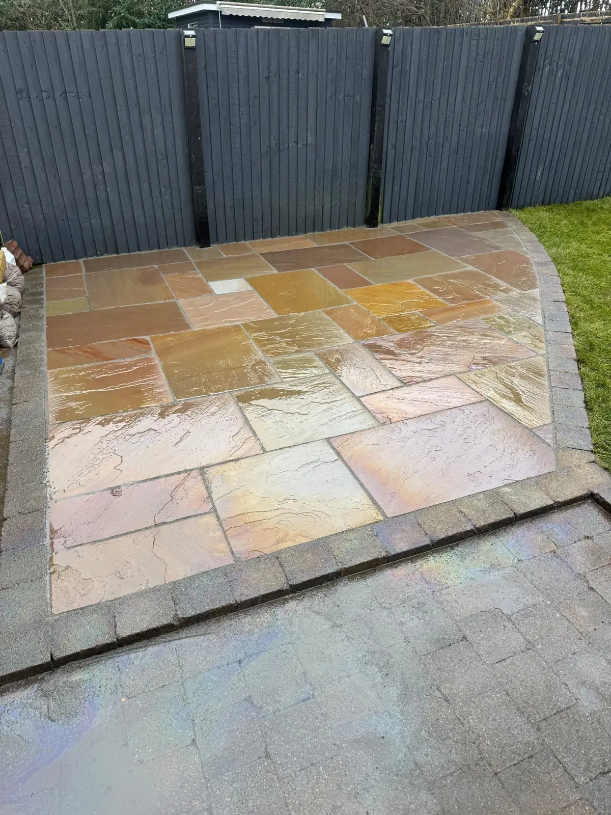 Sandstone patio with dark fencing