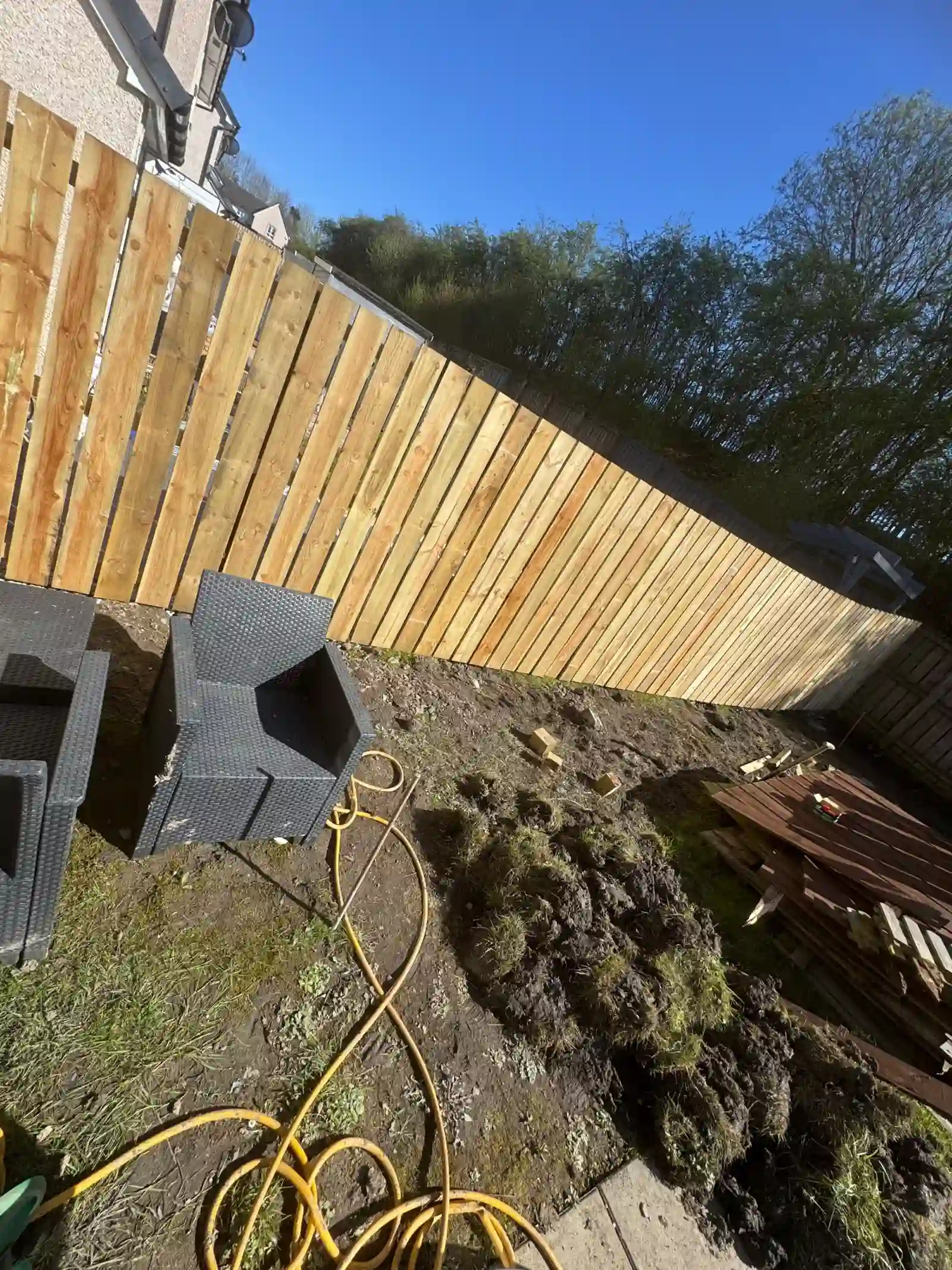 New timber fencing being installed along the garden boundary