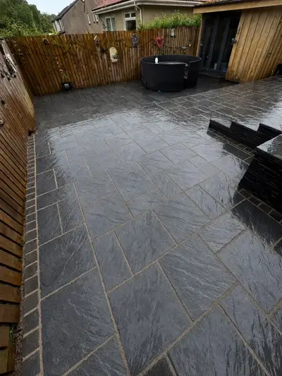 Large slate patio with raised beds