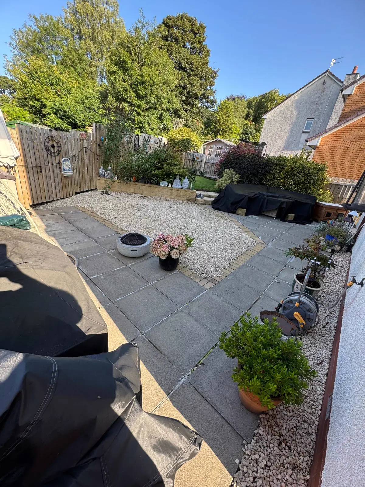 Back garden before: worn concrete slabs and gravel